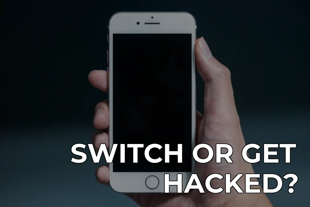a hand holding a white cell phone — SWITCH OR GET HACKED?